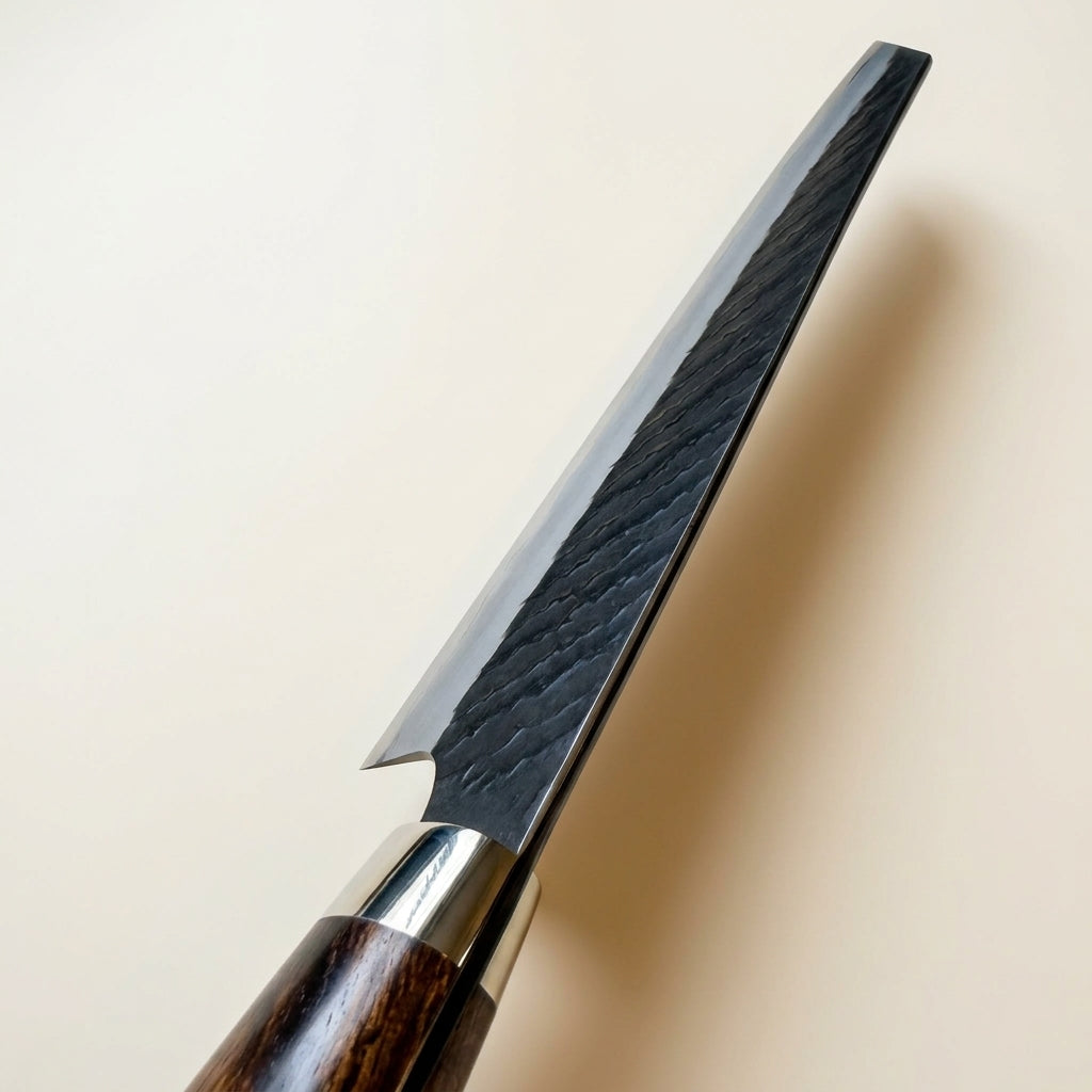 Top-down view showing k-tip profile and blade spine of hand-forged Nigara SG2 Kiritsuke knife with high quality polishing