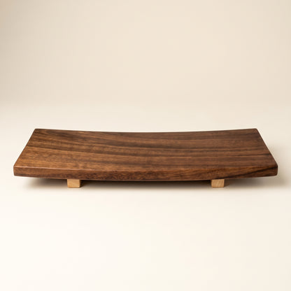 Fresh nigiri and sashimi artfully arranged on an authentic Japanese wooden sushi serving tray