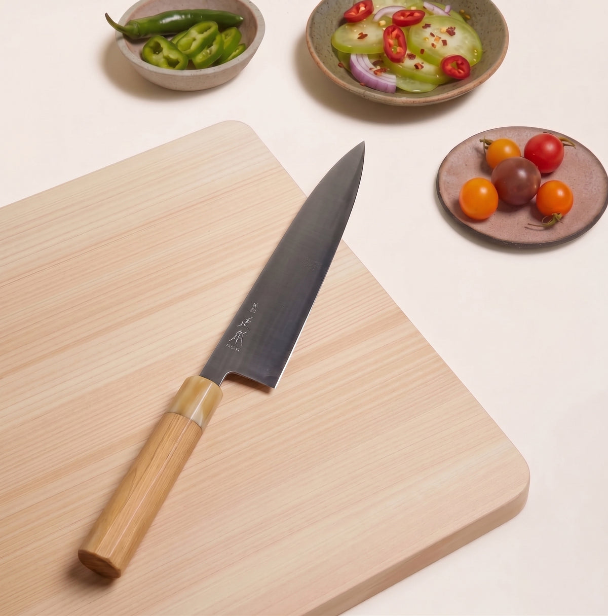 Octagonal magnolia wood handle with blonde water buffalo horn ferrule on Masamoto KS3124 on cutting board