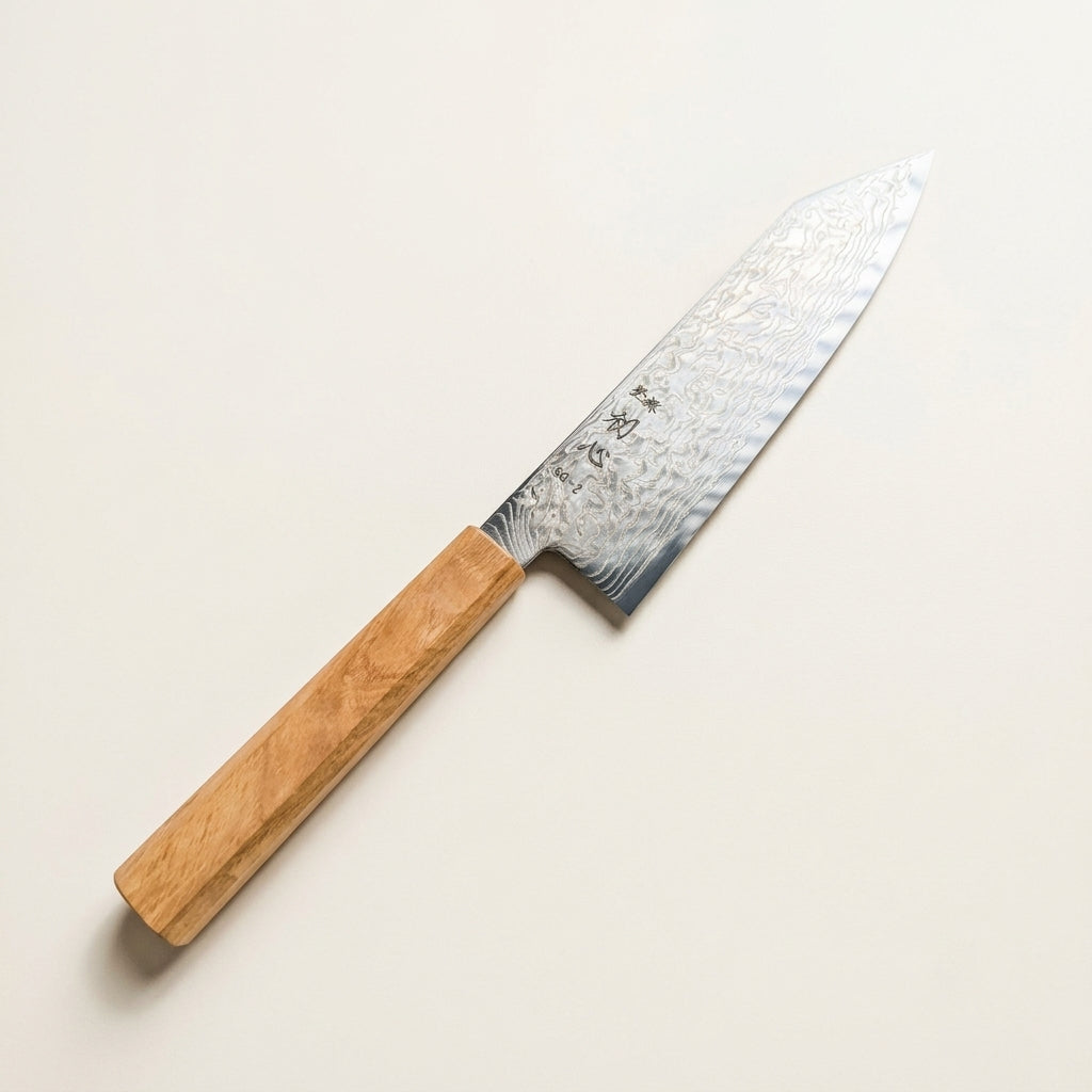 Detailed macro view of polished migaki damascus pattern, SG2 core edge, and sharp k-tip on Hatsukokoro Bunka
