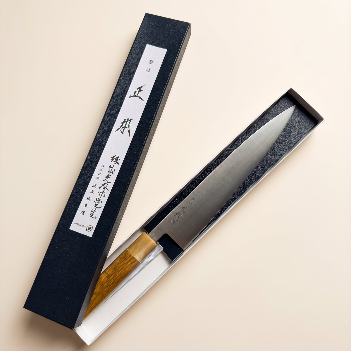 Octagonal magnolia wood handle with blonde water buffalo horn ferrule on Masamoto KS3124 in box
