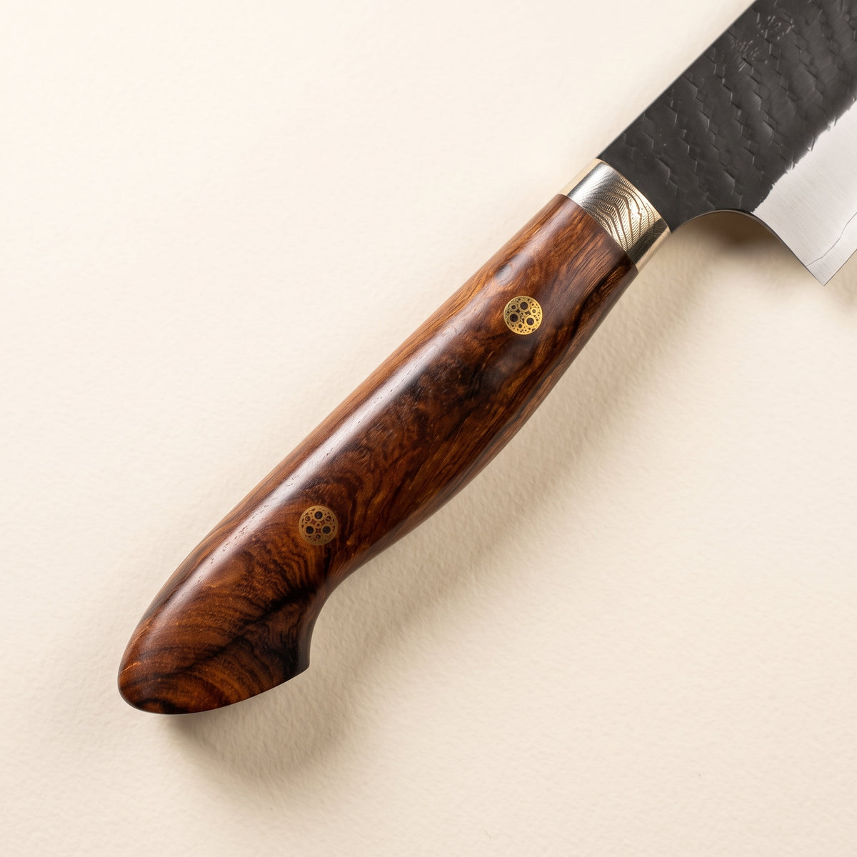 Close-up ironwood handle and hexagonal tsuchime hammer marks and black kurouchi finish on Nigara SG2 Kiritsuke blade