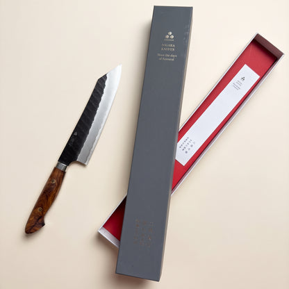 Top-down view showing k-tip profile and blade spine of hand-forged Nigara SG2 Kiritsuke knife next to original box