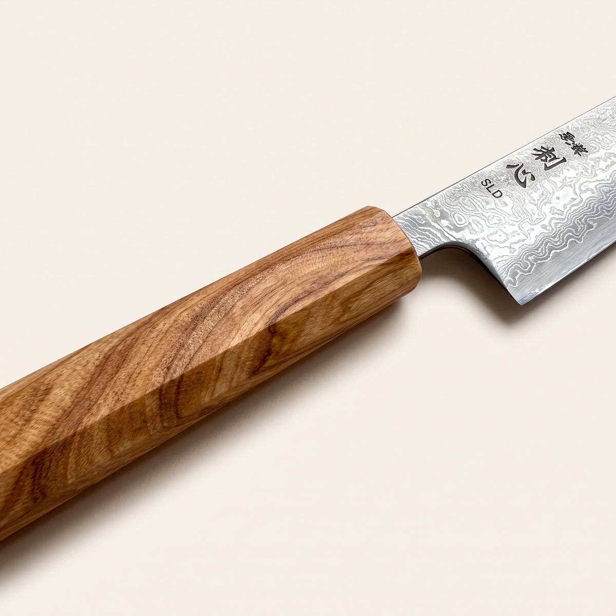 Octagonal Mediterranean olive wood wa-handle with natural wood grain fitted to a 130mm Japanese petty knife