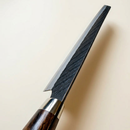 Top-down view showing k-tip profile and blade spine of hand-forged Nigara SG2 Kiritsuke knife with high quality polishing