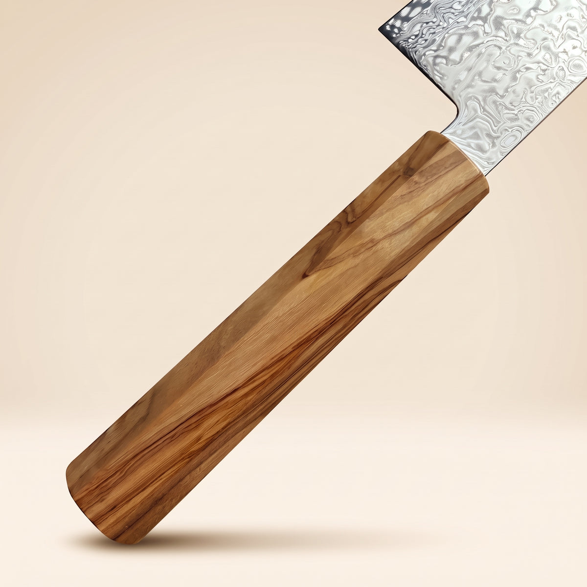 Octagonal Mediterranean olive wood wa-handle with rich wood grain figure attached to a Hatsukokoro Ryuhyo 240mm Gyuto