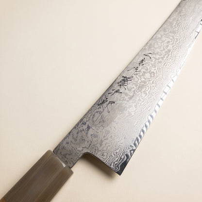 Close-up of hand-forged 66-layer damascus pattern and k-tip edge on Tojiro Atelier Kiritsuke